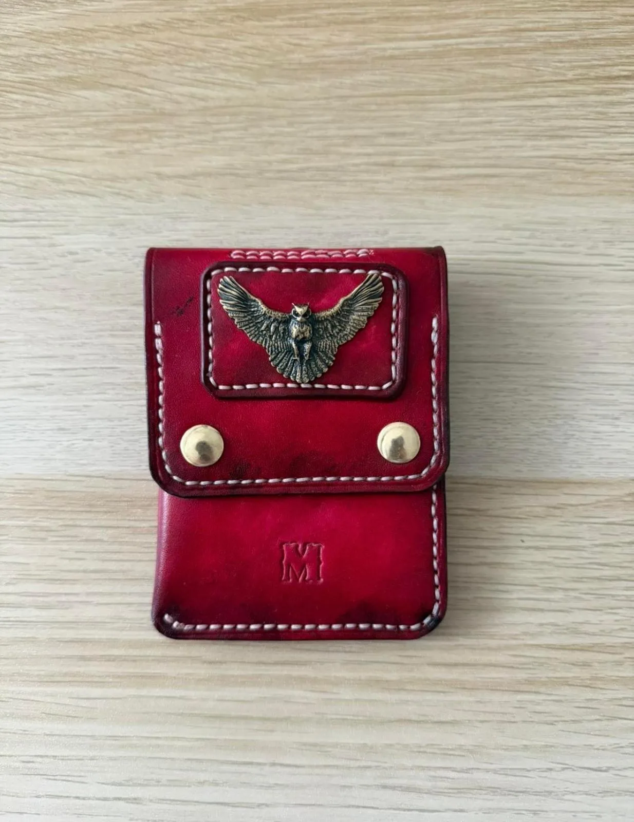 Oxblood case with a brass owl